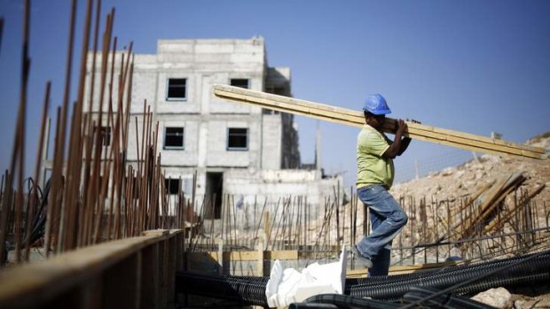 A labourer works on a construction site in Pisgat Zeev. Israel has approved 942 new settler homes in annexed east Jerusalem.