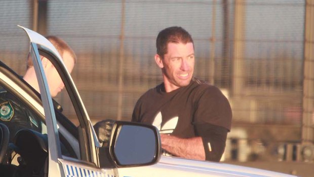 Bridge protester Michael Fox is taken into police custody after abseiling down.