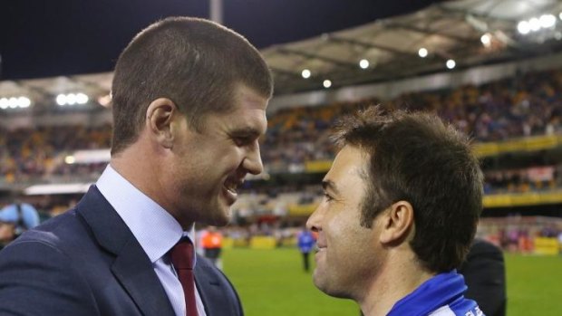 Brad Scott has a word with retiring Lions champion Jonathan Brown at the Gabba on Saturday.