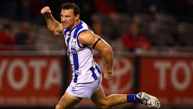 North Melbourne's Brent Harvey relishes an early goal against Essendon at Etihad Stadium.