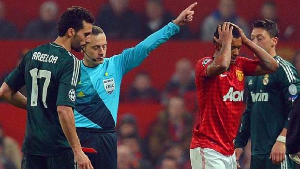 Manchester United's Portuguese midfielder Nani (R) is sent off.
