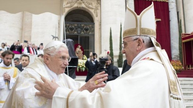 Pope Emeritus Benedict XVI and Pope Francis embrace before the ceremony.