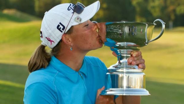Second time lucky . . . Katherine Hull kisses the Navistar LPGA trophy following victory in Alabama.