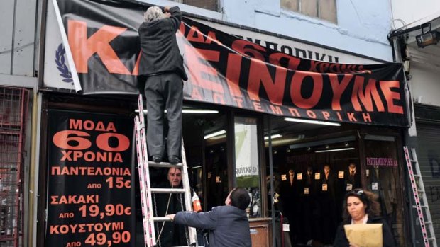 A shop banner in Athens reads: "60 years of fashion - Now we're closing".