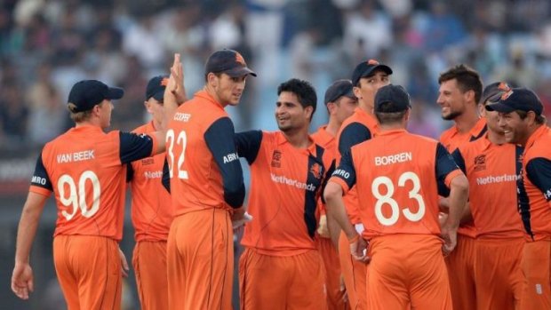 Netherlands bowler Mudassar Bukhari (centre) celebrates with his teammates after taking the wicket of England batsman Michael Lumb.