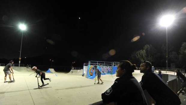Police from the Tuggeranong Station, Constables Justin Bateman and Rachel Thomson, keep a watch on young boys at the local skate park.
