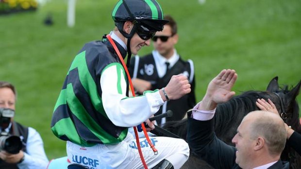 High five: Chad Schofield celebrates with trainer Danny O'Brien after winning the Cox Plate.
