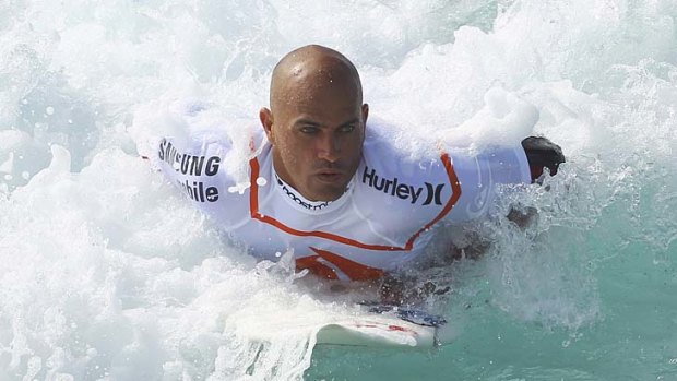 Looming large: Kelly Slater is into the final eight at the Pipe Masters in Hawaii.