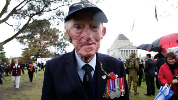 Soldiering on ... Veteran James Jack Moore refused to let the poor weather stop him from taking part in the Anzac Day parade through Melbourne today.