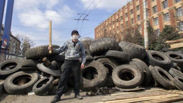 A pro-Russian activist in front of barricades at the security service building in Luhansk.