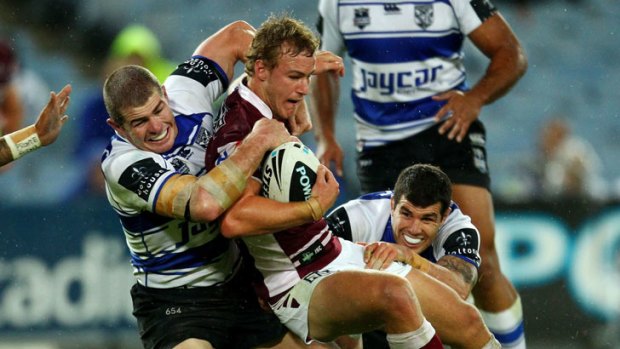 Young gun Daly Cherry-Evans of the Sea Eagles is tackled by the Bulldogs' defence.