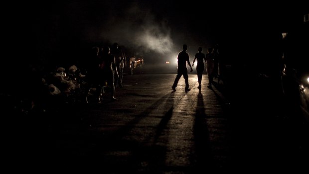 Earthquake survivors walk in the street in Port-au-Prince.