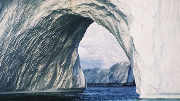 An iceberg tunnel in Greenland, where the effects of global warming are evident.