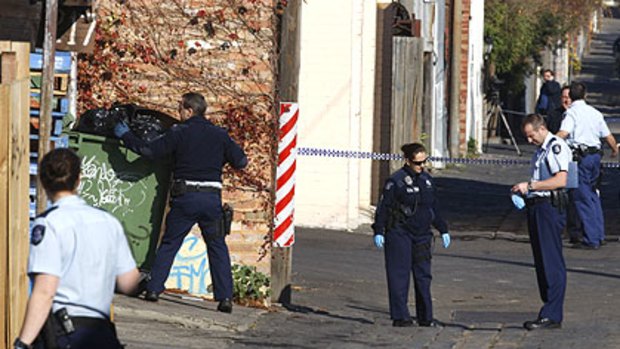 Police search Dutton Lane, Ascot Vale, behind the cafe where Des Moran was killed.