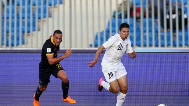 Giving chase: Tarek Elrich pursues Hamza Aldaradreh during the Socceroos' 2-0 loss to Jordan. 