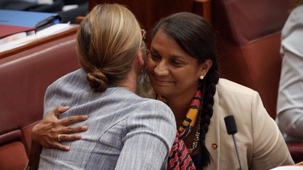 Senator Nova Peris is embraced by Senator Kate Lundy.