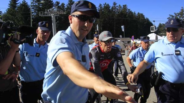 Lance Armstrong is escorted by French Gendarme after the 14th stage.
