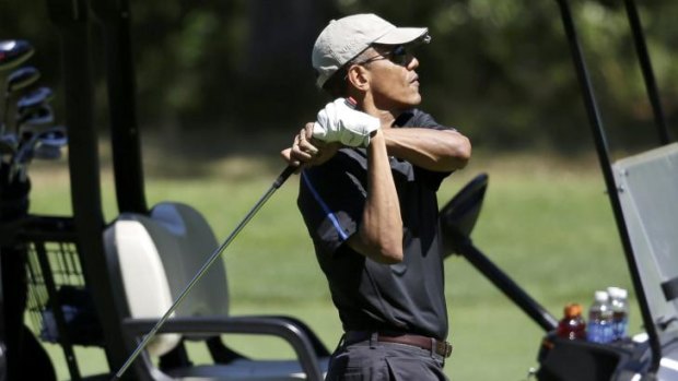 Not such a great holiday: President Barack Obama follows through on a swing while golfing on the island of Martha's Vineyard.