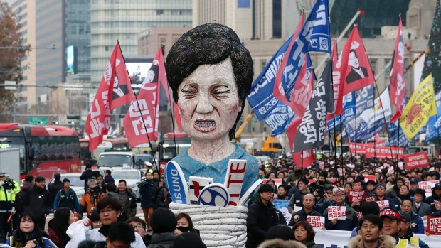 Members of the Korean Confederation of Trade Unions carry an effigy of South Korean President Park Geun-hye.