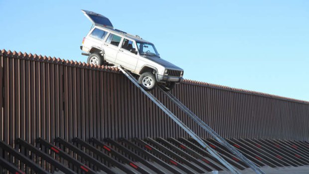 This vehicle became stuck on top of the US-Mexico border fence as it tried to cross into the US illegally last year.  As Customs agents arrived on the scene, two suspects fled into Mexico.