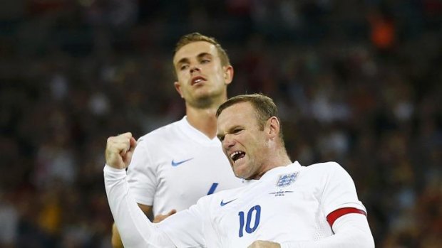 England captain Wayne Rooney (front) celebrates after scoring his penalty.
