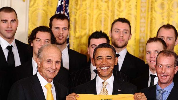 US President Barack Obama holds a Boston Bruins jersey as the National Hockey League champions visit the White House.