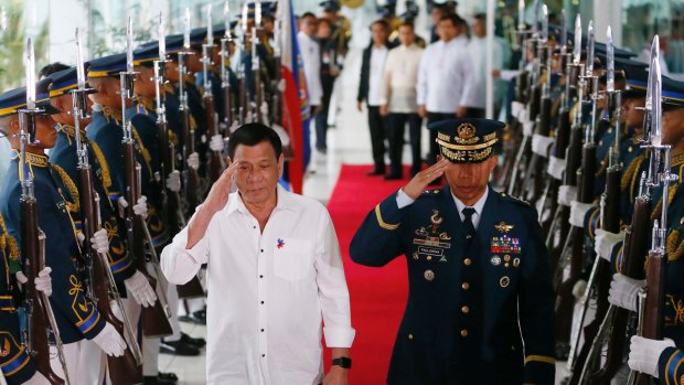 Asian affairs: Philippine President Rodrigo Duterte salutes the honour guard prior to his departure for Cambodia and Singapore.