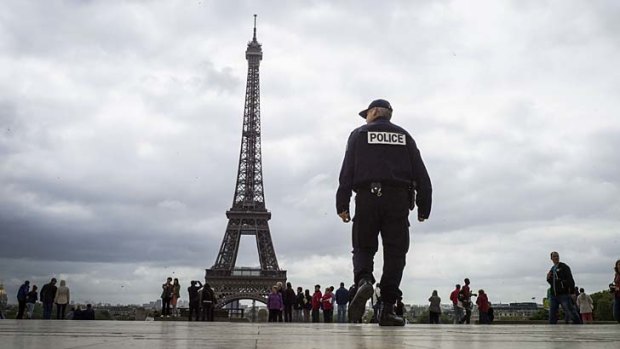 A policeman patrols on Trocadero Square in front of the Eiffel Tower. Paris has seen a rise in pickpocketings, muggings and theft targeting tourists.