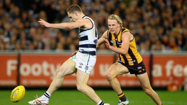 Joel Selwood of the Cats gets a kick away whilst being tackled by Will Langford of the Hawks. The Geelong captain was head and shoulders above the rest of the team in his on-field performance.