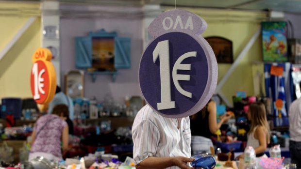 Customers browse through discounted goods at a 'one euro store'  in Athens.
