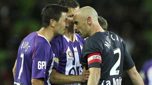Melbourne's Kevin Muscat and Jacob Burns of the Glory lock horns last night.