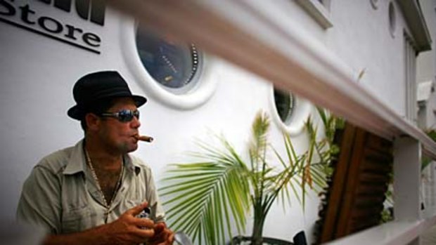 Smokin' ... a Cuban-American rolls a cigar in Miami's art deco district.