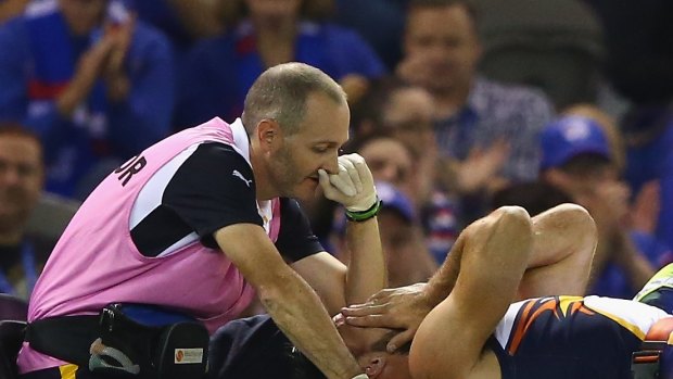 Mitchell Brown of the Eagles is taken from the ground with an injury during the round one AFL match between the Western Bulldogs and the West Coast Eagles at Etihad Stadium on April 4.