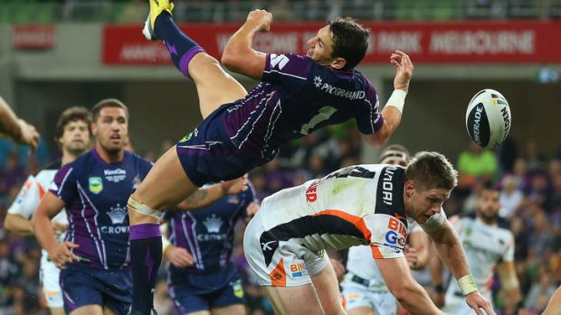 Billy Slater of the Storm attempts to catch the ball.