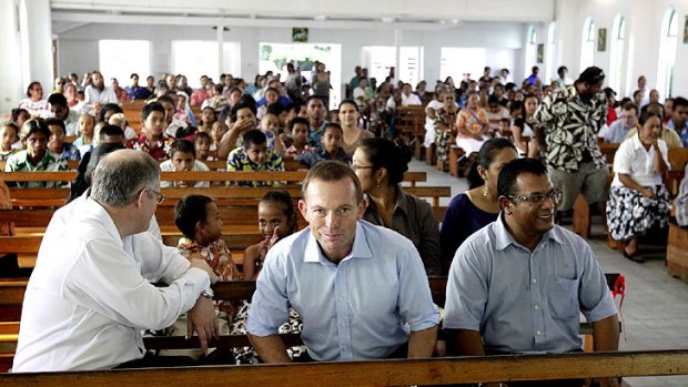 Opposition Leader Tony Abbott with Nauruan President Marcus Stephen (right) at Mass yesterday at Christ the King Catholic Church, where Mr Abbott gave the second reading.