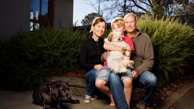 Matthew, Karen and Will Owen at home in Canberra with dogs Stella and Buddy.