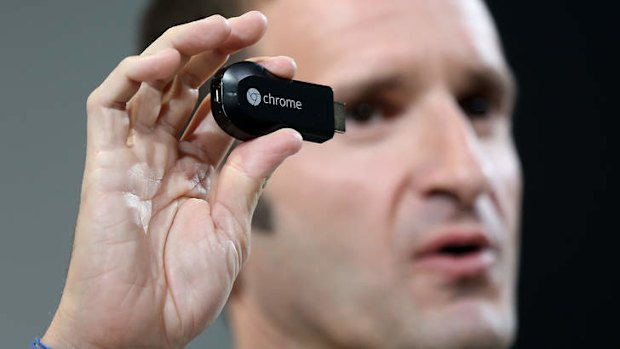 Mario Queiroz, vice president of product management at Google, holds up a new Google Chromecast SDK as he speaks during a special event at Dogpatch Studios.