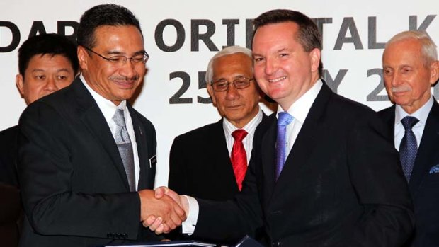 "All about political window-dressing at home" ... Immigration Minister Chris Bowen shakes on the Malaysia deal.