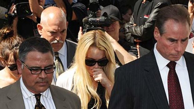 Lohan leaves court after the sentencing.
