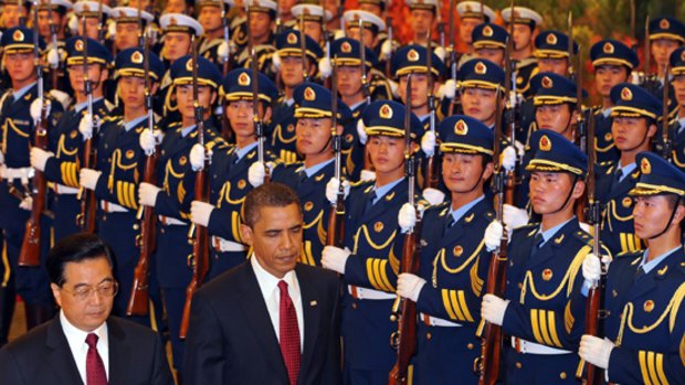 Hu Jintao and Barack Obama review the honour guard welcoming ceremony at the Great Hall of the People in Beijing.