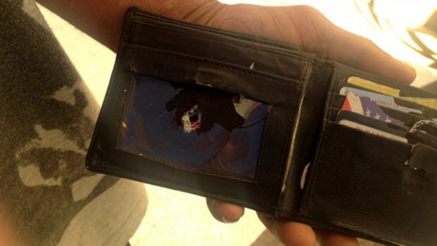 The wallet was in Brian Harris's pocket when the shooting began.