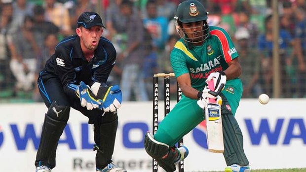 Bangladesh opener Shamsur Rahman attempts an unorthodox shot as New Zealand wicketkeeper Luke Ronchi looks on.