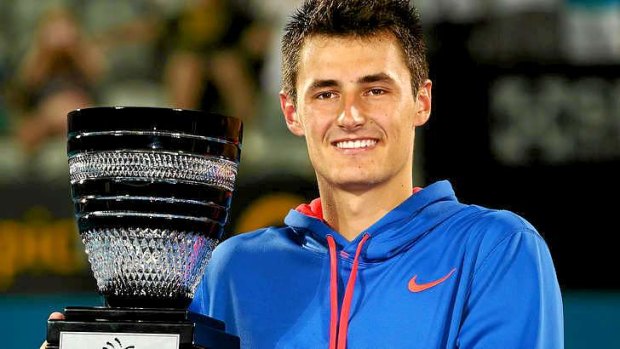 Bernard Tomic of Australia poses with the trophy after winning his inaugural ATP title in Sydney this year.