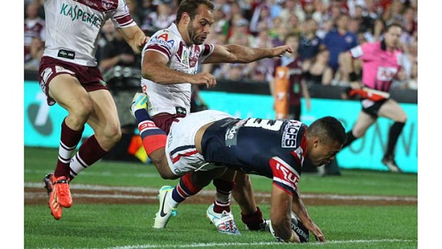 Sure thing: Rooster Michael Jennings scores a spectacular try against Manly in the second half of the grand final.