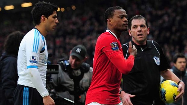 Controversial gesture: Patrice Evra celebrates Manchester United's 2-1 win after Liverpool's Luis Suarez refused to shake his hand.