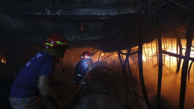 Firefighters try to control a fire inside a garment factory in the Bangladeshi town of Gazipur.