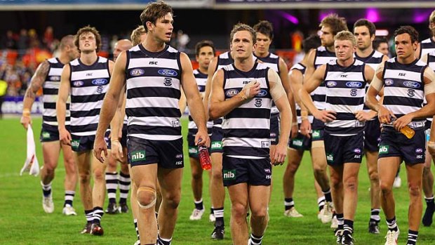 Joel Selwood and Tom Hawkins lead the Cats off the field after the win against the Suns.