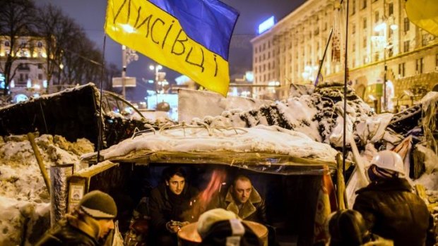 Front line: Protesters in  shelter built to barricade the street near Independence Square.
