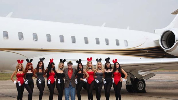Playboy founder Hugh Hefner (centre) arrives at Stansted Airport ahead of the opening of the Playboy Club.