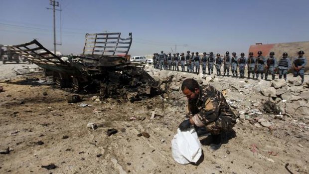 Seven killed: Afghan security personnel at the site of an attack on NATO's airport headquarters.